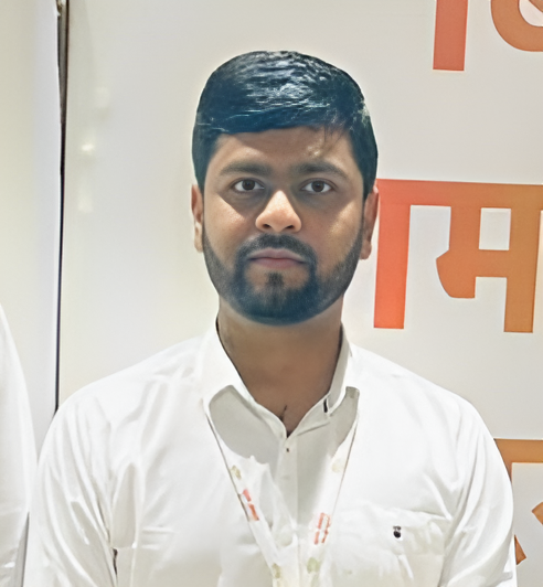 professional portrait of an Indian man in business attire, confident pose, modern office background
